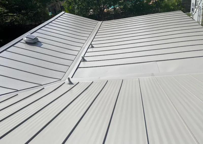 Solar attic fan installed on a metal roof for Roof Ventilation in Garland